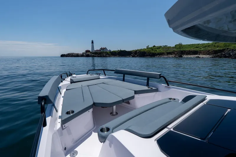 Slide: The Image of 2026 Axopar 29 XC Cross Cabin boat with Mercury engines in a showroom. - 29