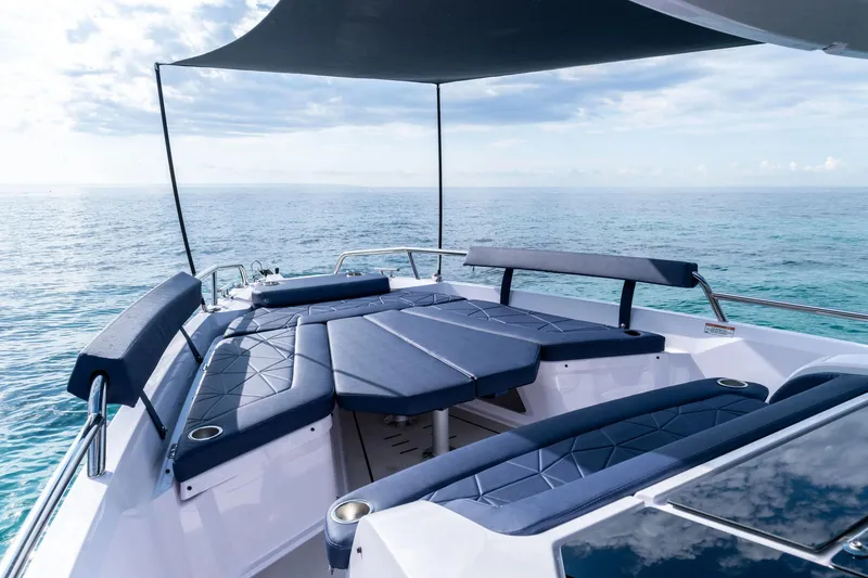 Slide: The Image of 2026 Axopar 29 XC Cross Cabin boat in a showroom, showcasing sleek design and modern features. - 3