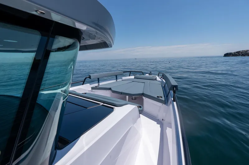 Slide: The Image of 2026 Axopar 29 XC Cross Cabin storage compartment with open lid and cushions inside. - 34