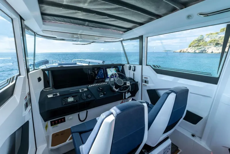 Slide: The Image of 2026 Axopar 29 XC Cross Cabin interior with modern seating and panoramic windows. - 7