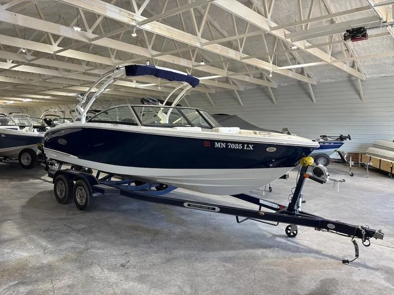 Slide: The Image of 2019 Cobalt CS23 Surf boat on trailer in indoor storage facility. - 1
