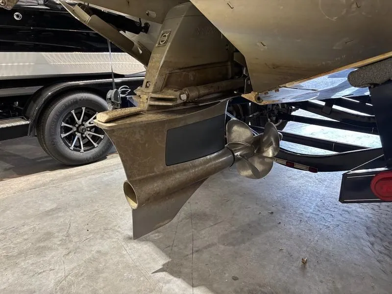 Slide: The Image of 2019 Cobalt CS23 Surf boat propeller and stern drive in a garage setting. - 3