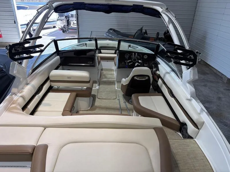 Slide: The Image of 2019 Cobalt CS23 Surf boat interior with beige seating and modern dashboard. - 4