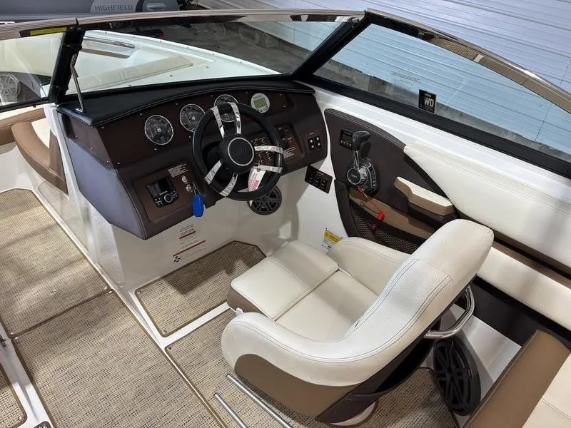 Slide: The Image of 2019 Cobalt CS23 Surf boat interior with steering wheel and dashboard controls. - 5