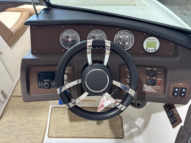 Slide: The Image of 2019 Cobalt CS23 Surf boat dashboard with steering wheel and control gauges. - 7