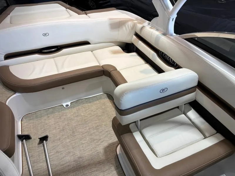 Slide: The Image of 2019 Cobalt CS23 Surf boat interior with white and brown seating. - 8