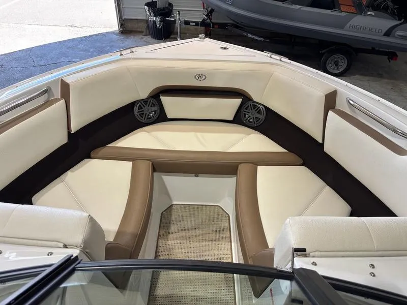 Slide: The Image of 2019 Cobalt CS23 Surf boat interior with beige and brown seating, featuring built-in speakers. - 9