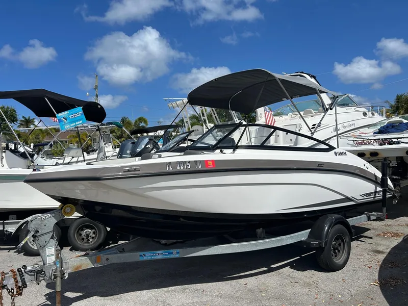 Slide: The Image of 2022 Yamaha SX190 boat on trailer under clear blue sky. - 21