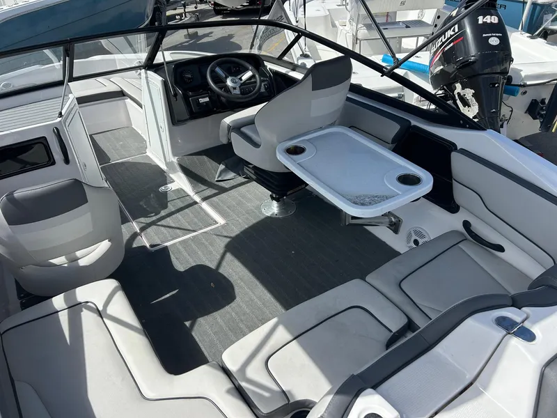 Slide: The Image of 2022 Yamaha Boats SX190 interior with seating, steering wheel, and table setup. - 5