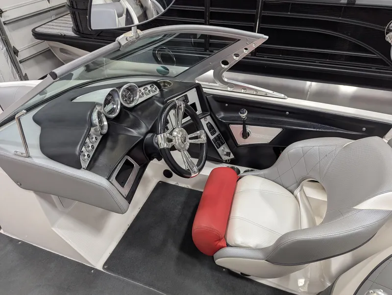 Slide: The Image of 2012 MasterCraft X-14 boat interior with steering wheel and dashboard. - 10