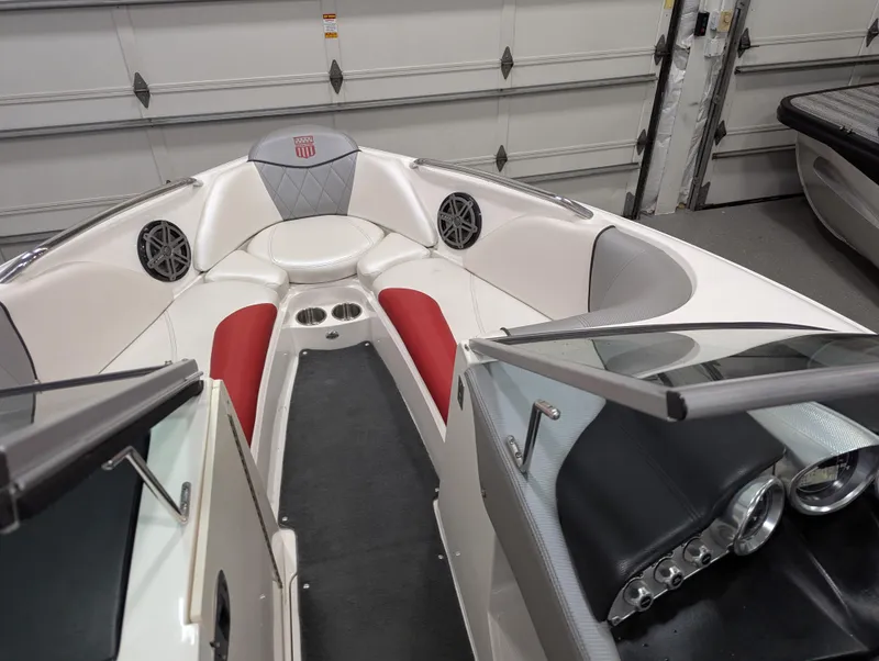 Slide: The Image of 2012 MasterCraft X-14 boat interior with red and white seating, dashboard, and speakers. - 11