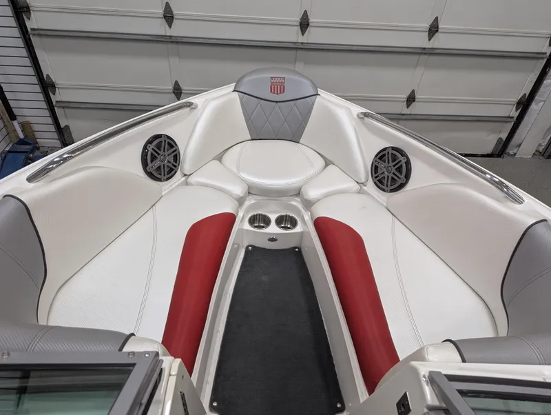 Slide: The Image of 2012 MasterCraft X-14 boat interior with red and white seating, cup holders, and speakers. - 12