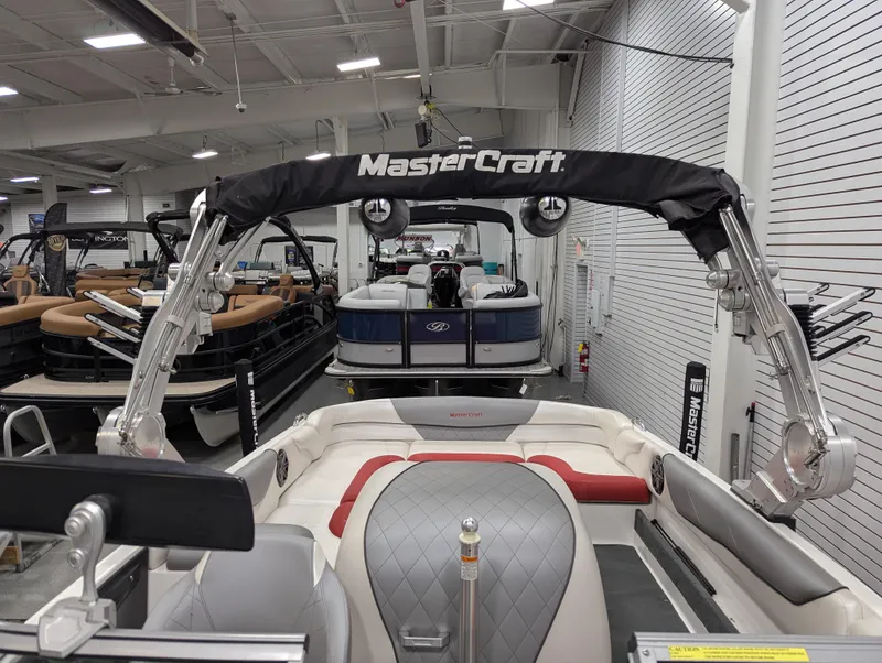 Slide: The Image of 2012 MasterCraft X-14 boat in showroom, featuring sleek interior and wakeboard tower. - 17