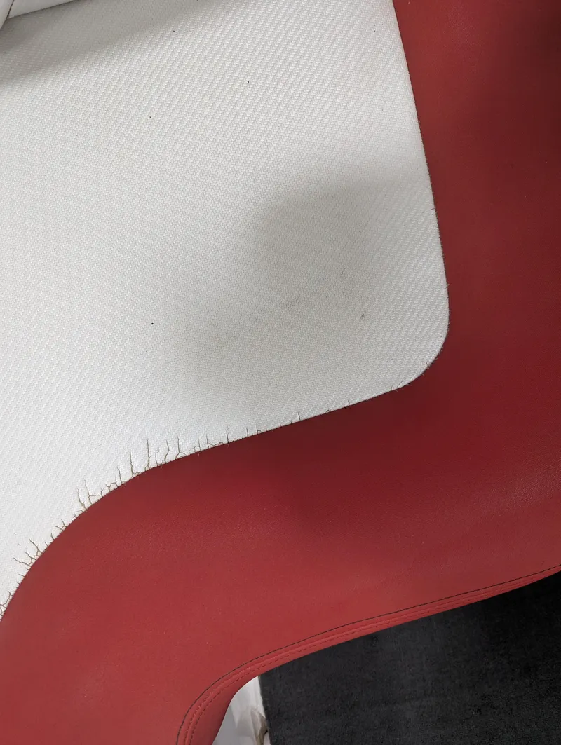Slide: The Image of Red and white upholstery detail of a 2012 MasterCraft X-14 boat seat. - 22
