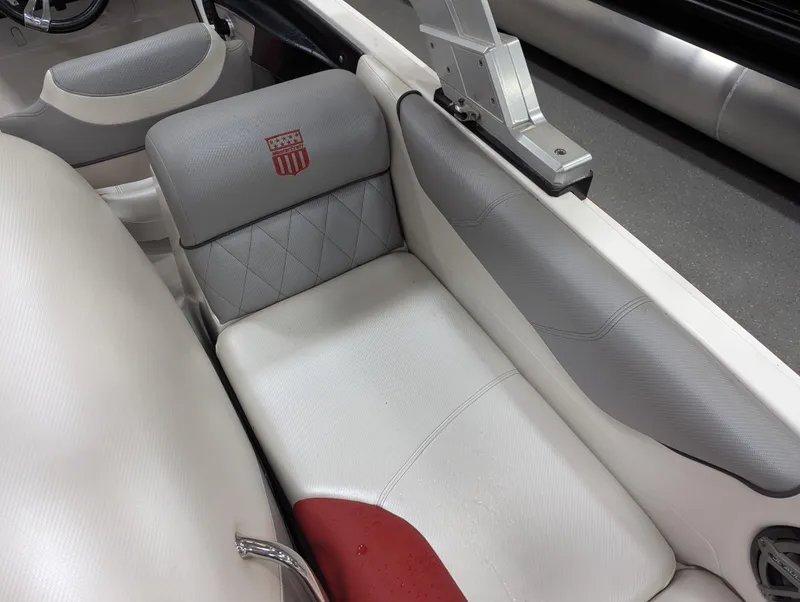 Slide: The Image of 2012 MasterCraft X-14 boat interior with gray and white seating, featuring a red accent. - 27
