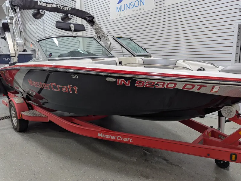 Slide: The Image of 2012 MasterCraft X-14 boat on red trailer in showroom. - 5