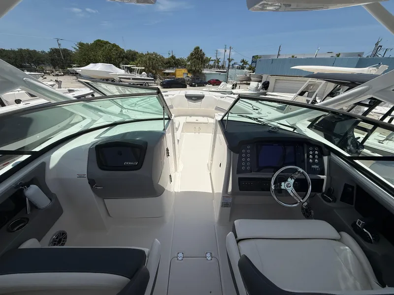 Slide: The Image of 2024 Robalo R317 Dual Console boat interior with modern dashboard and seating. - 11