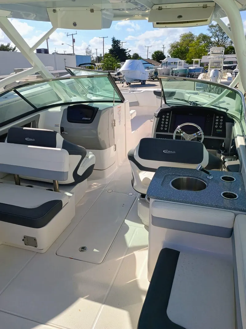 Slide: The Image of 2024 Robalo R317 Dual Console boat interior with seating and helm. - 18