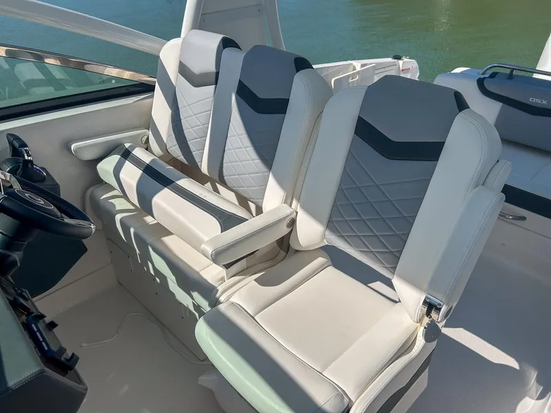 Slide: The Image of 2024 Chaparral 280 OSX boat interior with modern, cushioned seating and elegant design. - 15