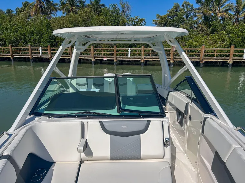 Slide: The Image of 2024 Chaparral 280 OSX boat interior with sleek design and spacious seating. - 4