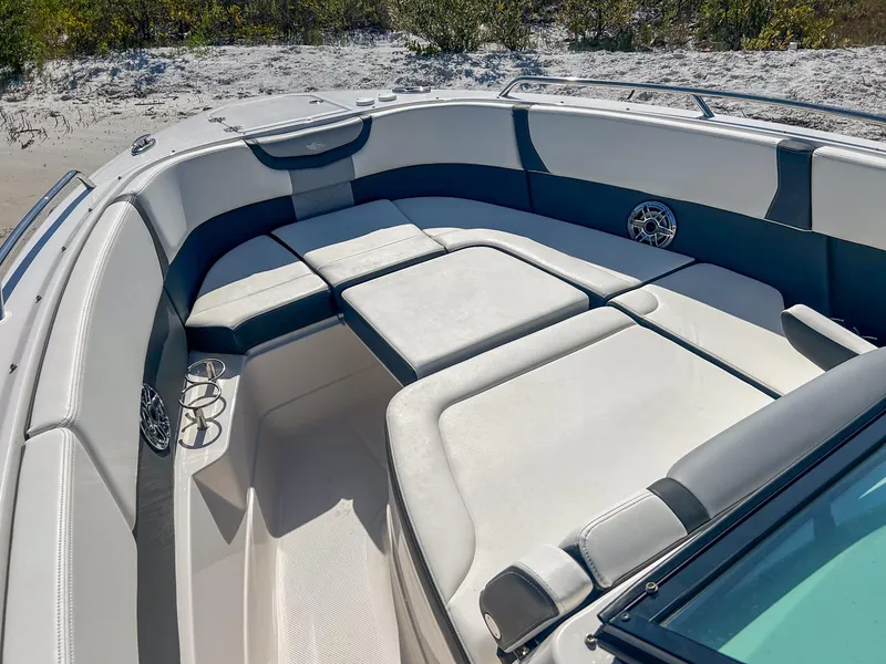 Slide: The Image of 2024 Chaparral 280 OSX boat interior with spacious seating and cup holders. - 5
