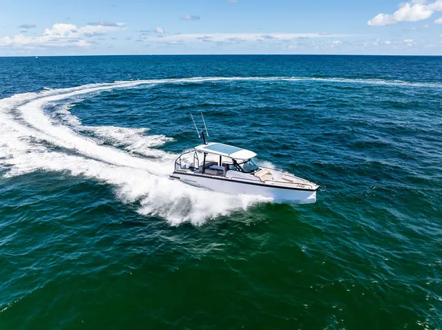 Slide: The Image of 2026 Axopar 29 Sun-Top boat with open storage compartment on a sunny day. - 39