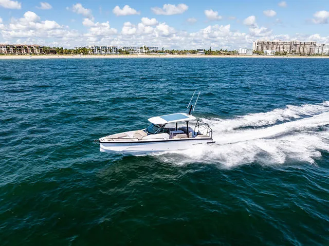 Slide: The Image of Interior cabin of 2026 Axopar 29 Sun-Top boat with gray seating and wooden accents. - 40