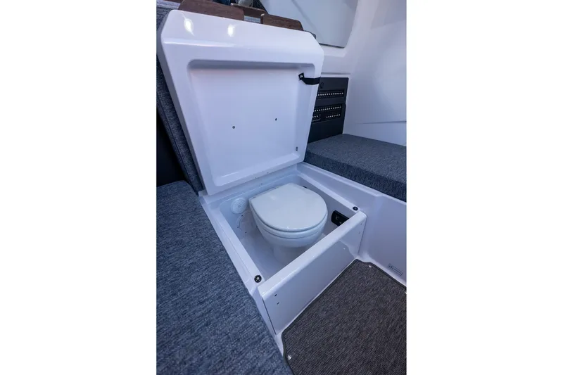 Slide: The Image of 2026 Axopar 29 Sun-Top boat interior with hidden toilet compartment. - 42