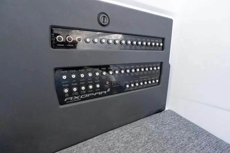 Slide: The Image of Control panel of 2026 Axopar 29 Sun-Top boat, featuring labeled switches and buttons. - 44