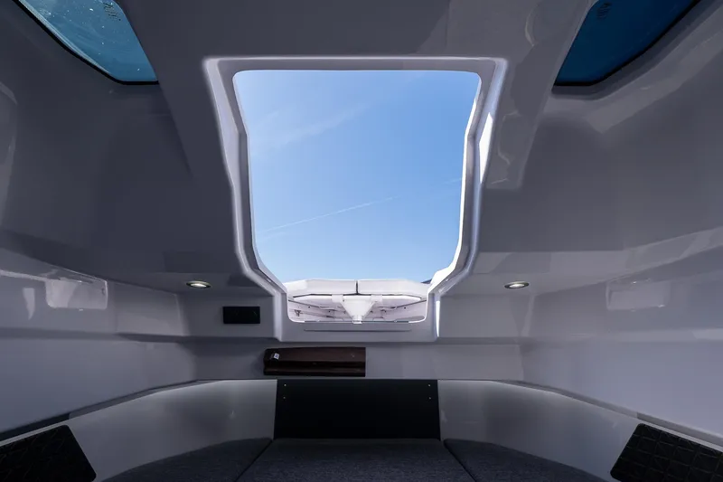 Slide: The Image of Interior view of 2026 Axopar 29 Sun-Top boat with open sunroof and sleek design. - 46