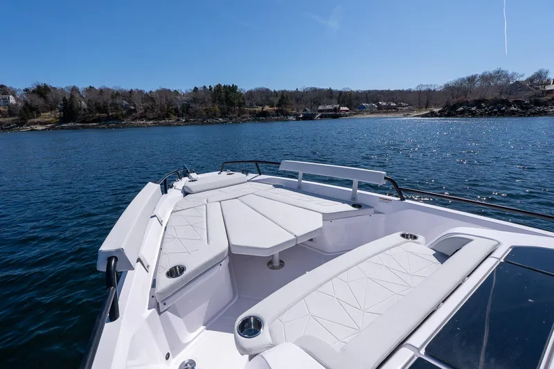 Slide: The Image of 2026 Axopar 29 Sun-Top boat with spacious seating on calm water. - 48