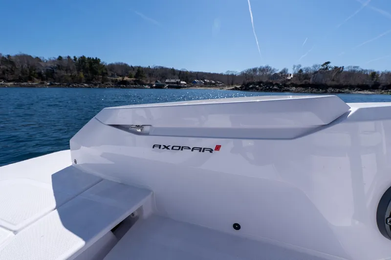 Slide: The Image of 2026 Axopar 29 Sun-Top boat on calm water with scenic shoreline. - 54