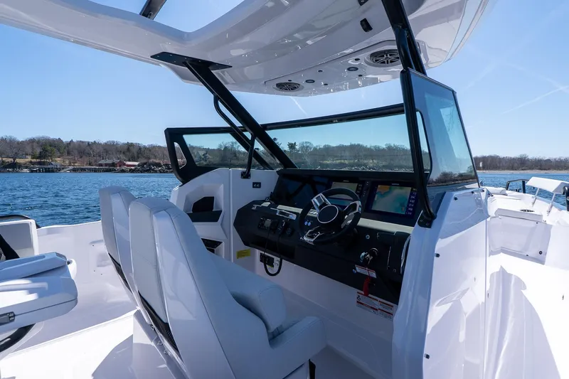 Slide: The Image of Interior view of 2026 Axopar 29 Sun-Top boat with modern cockpit design. - 65