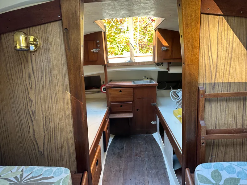Slide: The Image of Interior of 1968 Allied Greenwich 24 sailboat with wooden cabinetry and seating. - 13