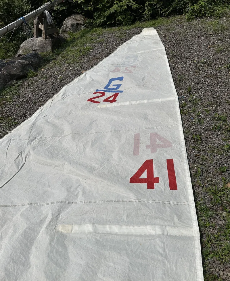 Slide: The Image of Sail from 1968 Allied Greenwich 24 boat, displayed on gravel with visible numbers. - 17