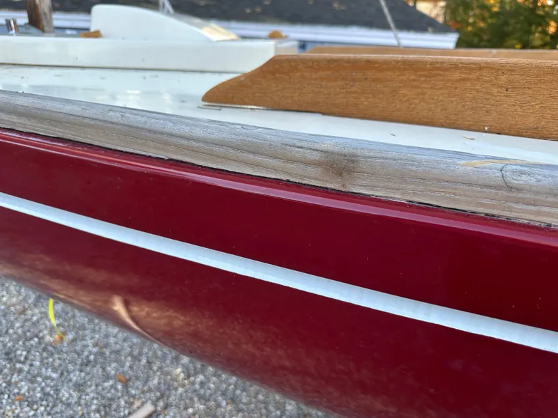 Slide: The Image of 1968 Allied Greenwich 24 sailboat with red hull and wooden trim detail. - 2