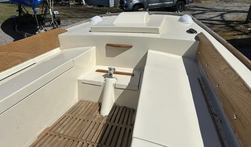 Slide: The Image of 1968 Allied Greenwich 24 sailboat interior with wooden accents and seating. - 8