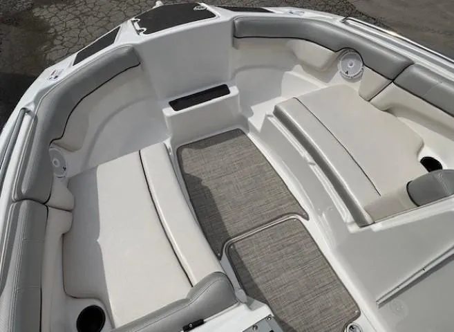 Slide: The Image of 2012 Yamaha AR210 boat interior with cushioned seating and gray flooring. - 10