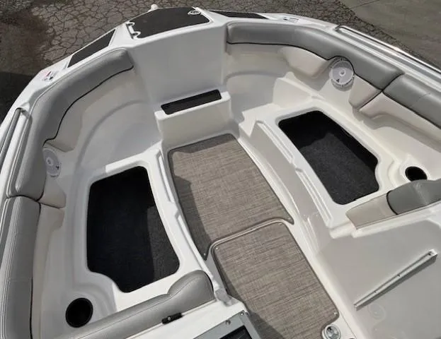 Slide: The Image of 2012 Yamaha AR210 boat interior with gray seating and carpeted flooring. - 11