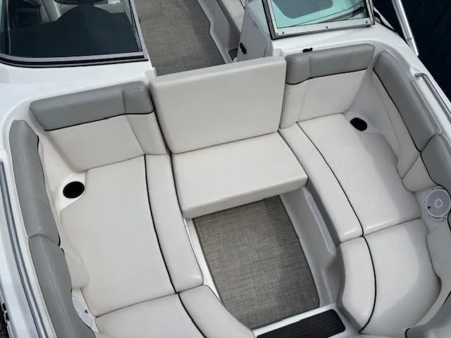 Slide: The Image of 2012 Yamaha AR210 boat interior with white cushioned seating and cup holders. - 13