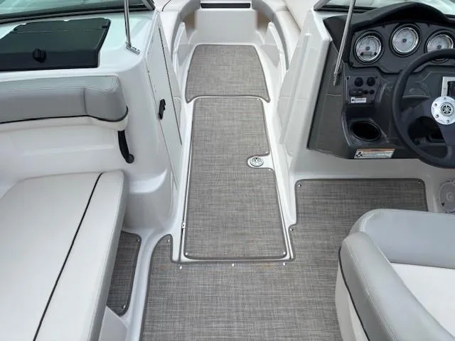 Slide: The Image of 2012 Yamaha AR210 boat interior with gray seating and dashboard. - 14