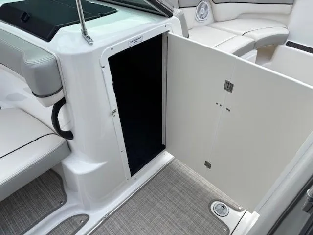 Slide: The Image of 2012 Yamaha AR210 boat interior with open storage compartment and seating area. - 17
