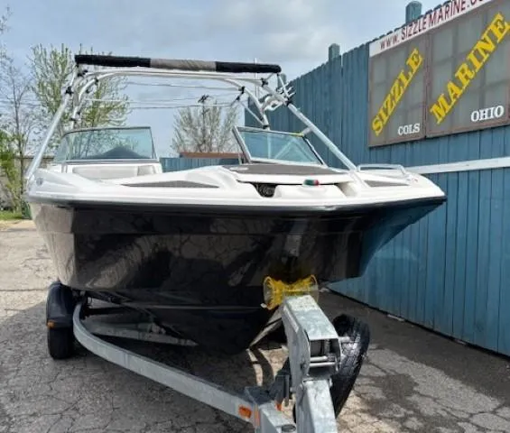 Slide: The Image of 2012 Yamaha AR210 boat on trailer, parked near Sizzle Marine sign, Ohio. - 2