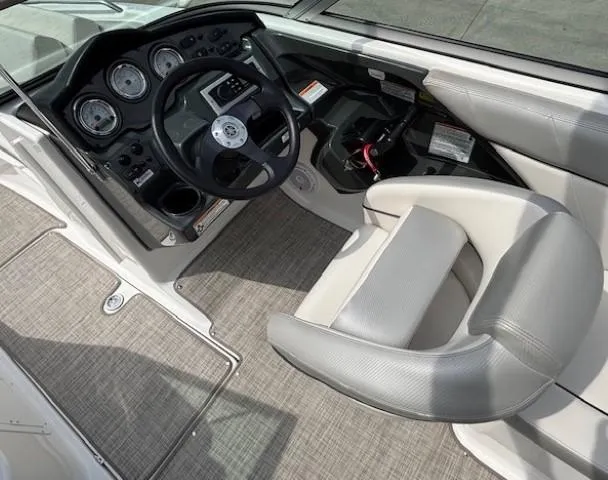 Slide: The Image of 2012 Yamaha AR210 boat cockpit with steering wheel and control panel. - 21