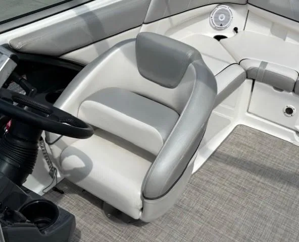 Slide: The Image of 2012 Yamaha AR210 boat interior with gray and white seating and steering wheel. - 22