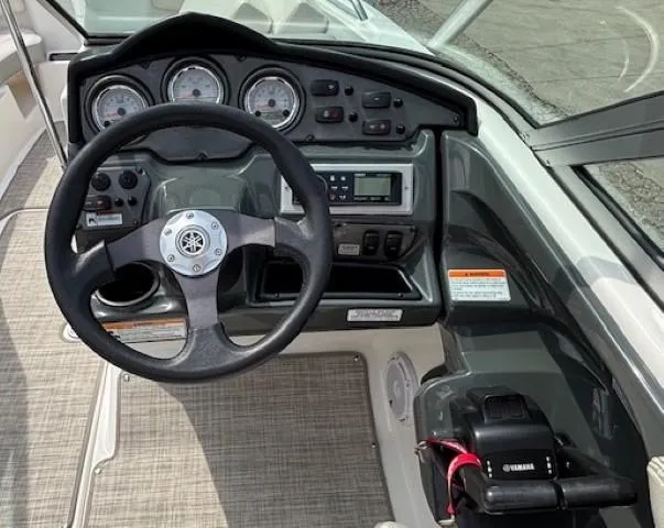 Slide: The Image of Steering console of a 2012 Yamaha AR210 boat with gauges and controls. - 23