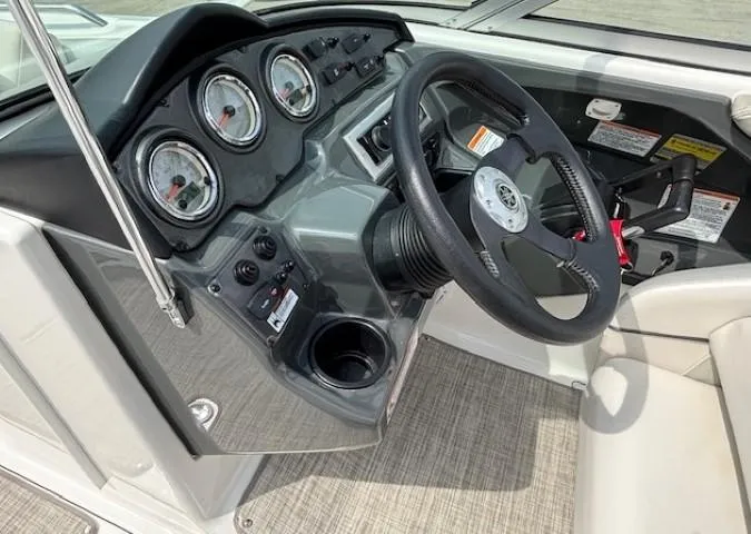 Slide: The Image of 2012 Yamaha AR210 boat dashboard with steering wheel and gauges. - 24