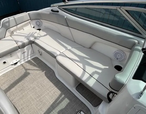 Slide: The Image of 2012 Yamaha Boats AR210 interior with white seating and carpeted floor. - 27