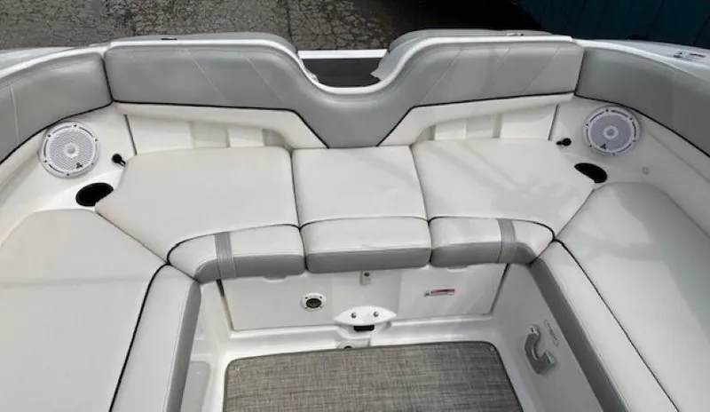 Slide: The Image of 2012 Yamaha AR210 boat interior with white cushioned seating and built-in speakers. - 31