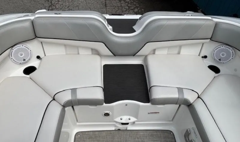 Slide: The Image of 2012 Yamaha AR210 boat interior with gray seating and speakers. - 32
